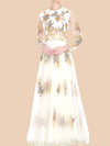  Ivory gown featuring floral embroidery and sheer sleeves, adorned with gold lace appliqué for a timeless elegance.