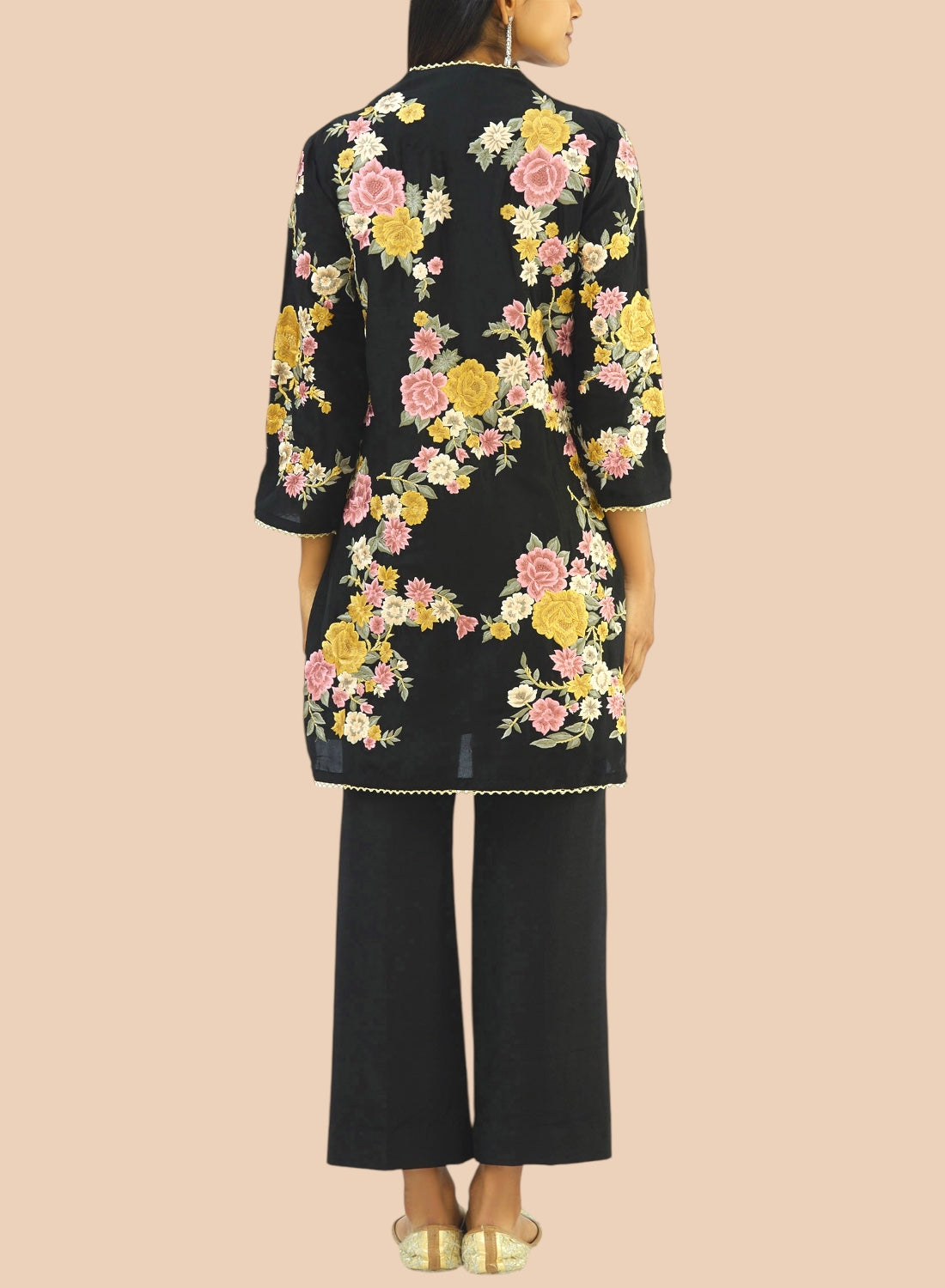 Black pure silk suit featuring floral embroidery, paired with narrow trousers and a delicate net dupatta for a refined look.