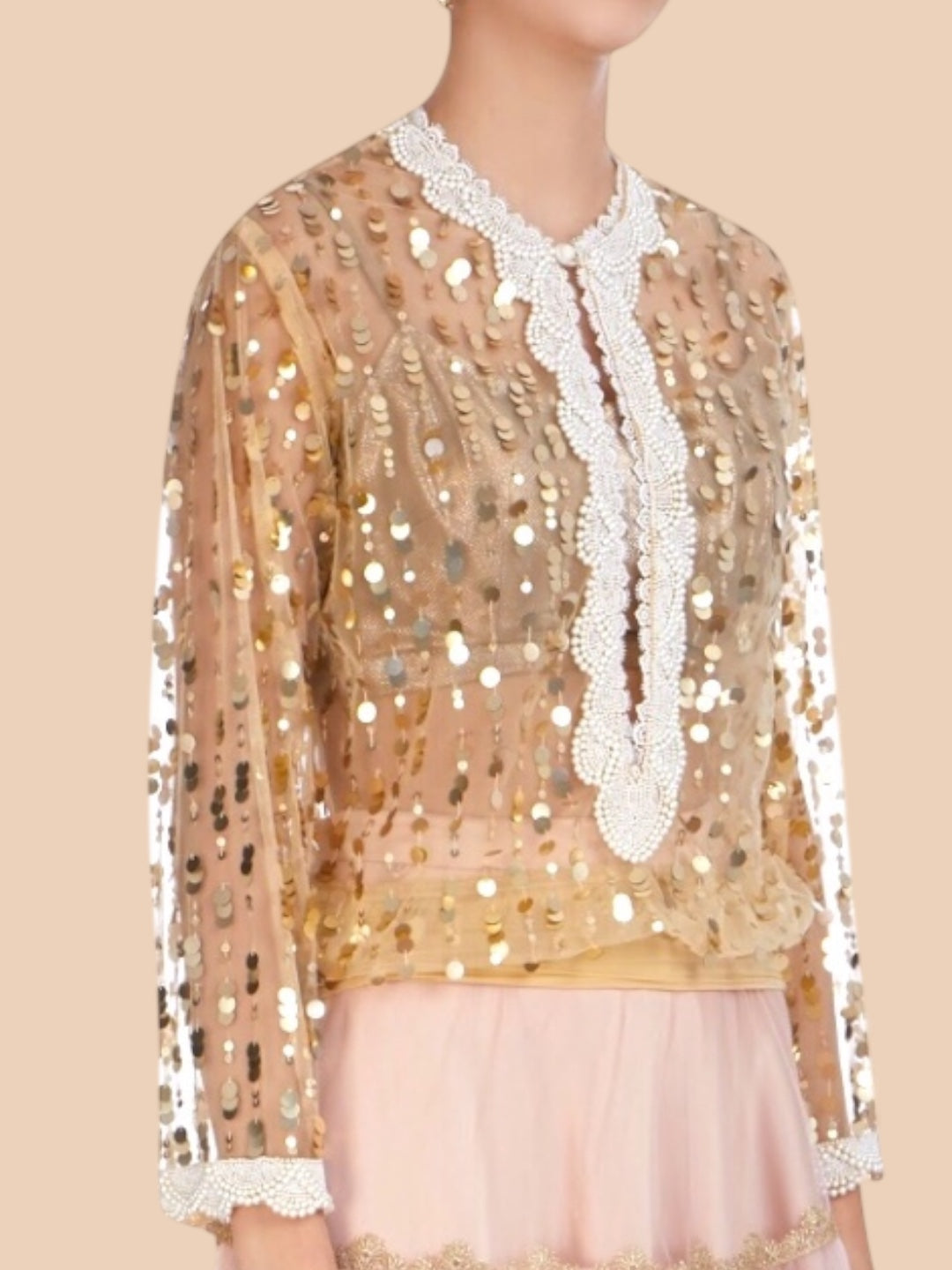Elegant nude net blouse adorned with gold sequins and pearl embroidery at the neck and cuffs, exuding effortless style.  
