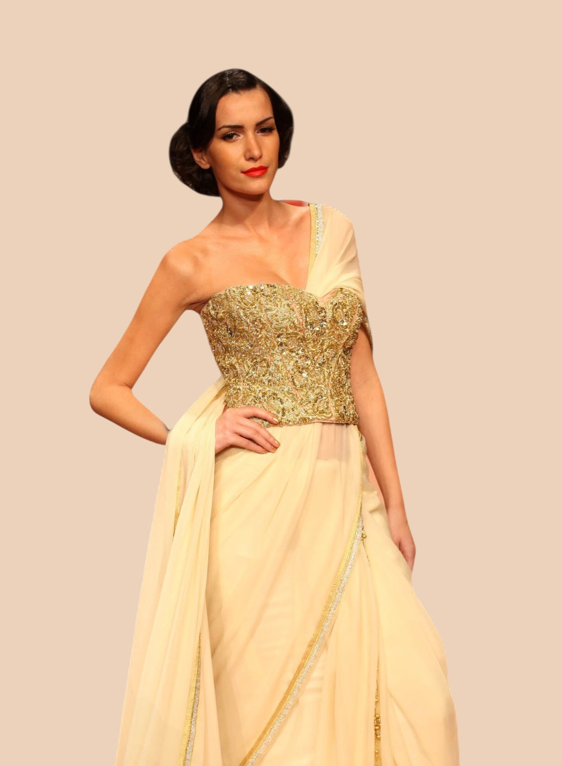 Woman wearing a gold and beige corset with a plain background