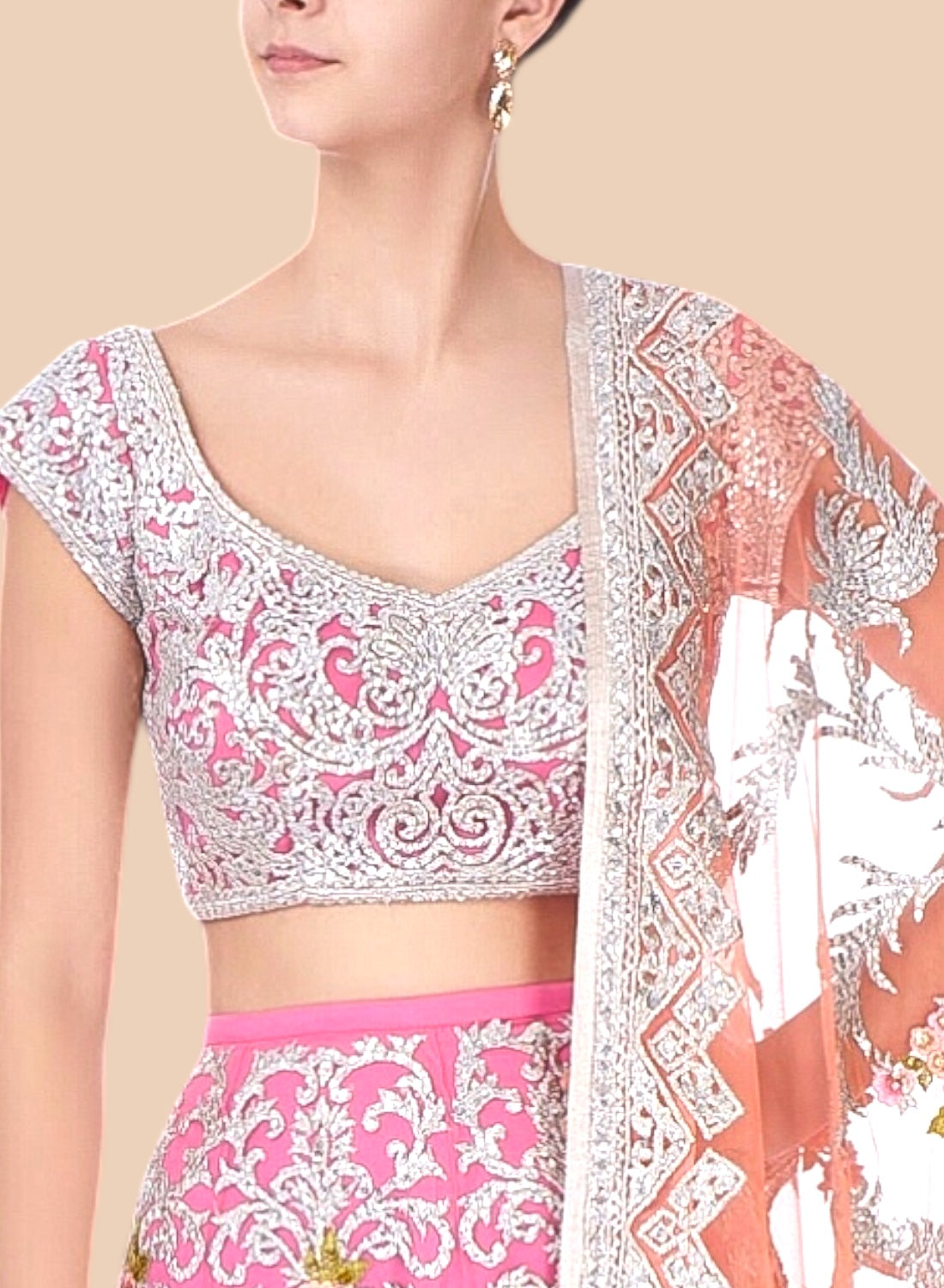 Woman wearing a traditional outfit with pink and white patterns on a beige background