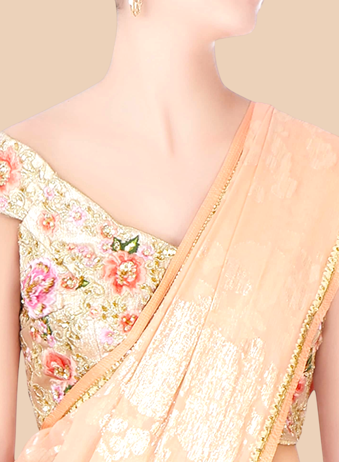 Close-up of a peach saree with floral embroidery on a neutral background