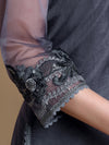 Close-up of a dark gray garment with intricate lace and embroidery details.