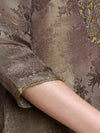 Close-up of a person wearing a floral-patterned garment with gold trim.