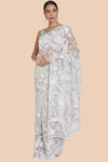 Full look of the white net sari worn with stilettos and styled accessories
