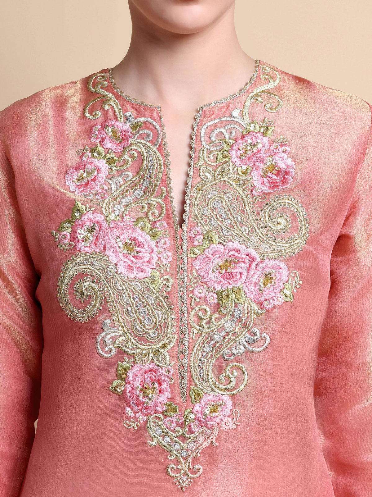 Close-up of floral and paisley zari embroidery on pink silk kurta