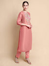 Side angle showing silhouette and embroidery of pink tissue kurta