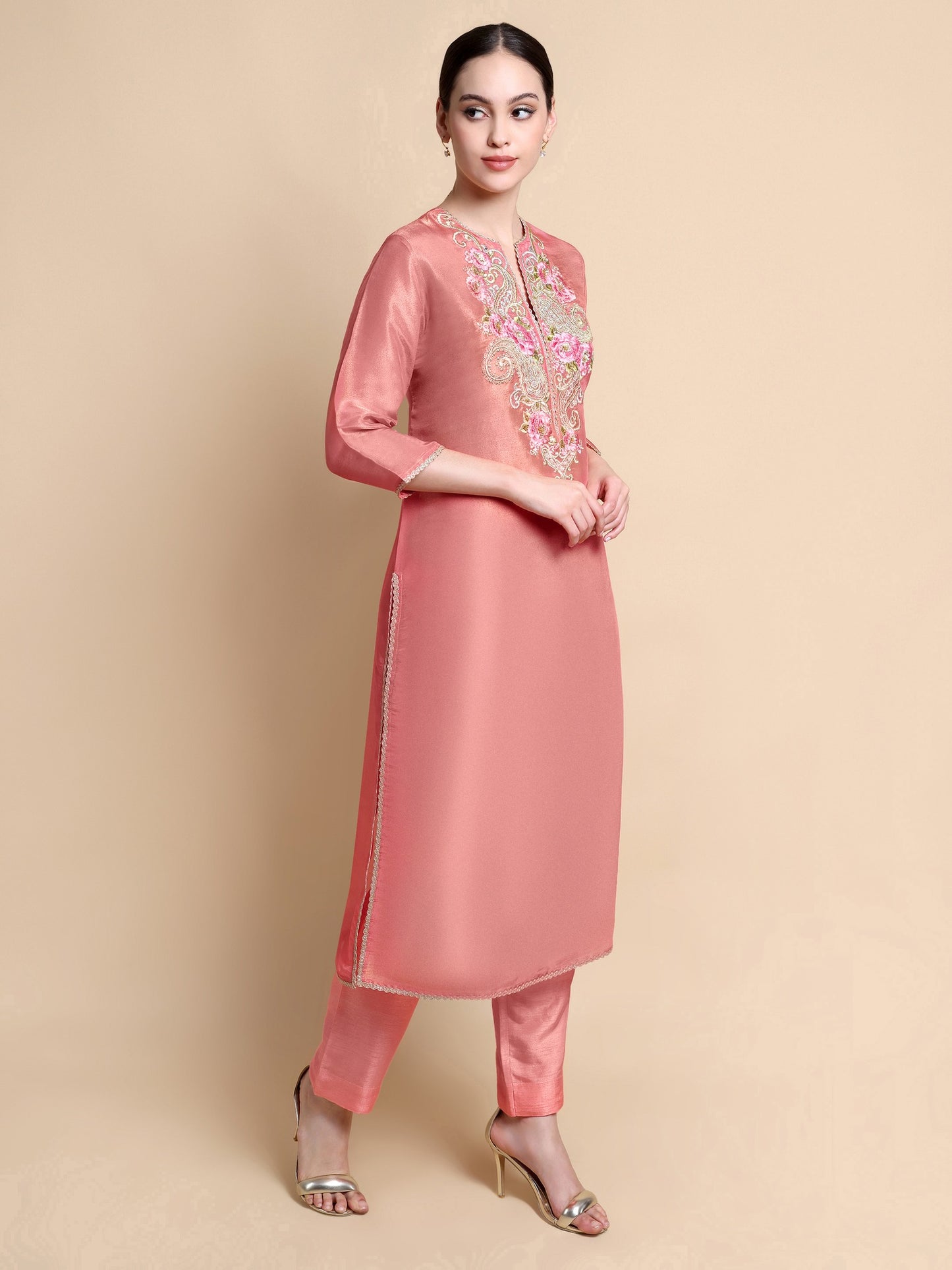 Side angle showing silhouette and embroidery of pink tissue kurta