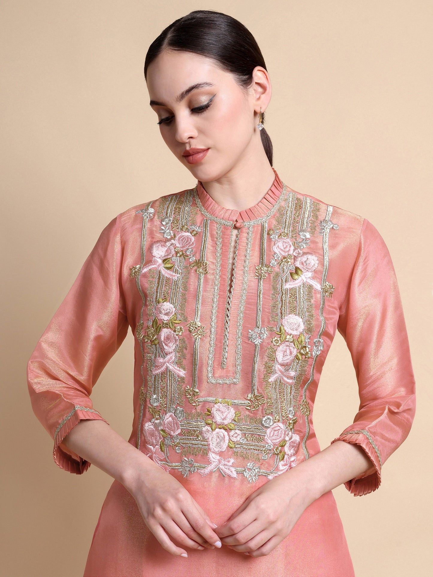Front view of pink tissue silk kurta with floral embroidery at the neckline and Dupion trousers
